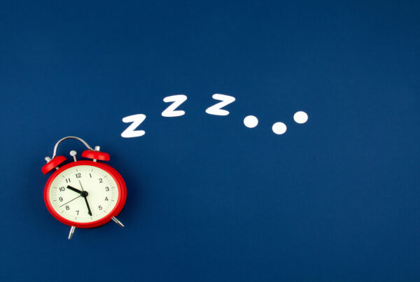 Snoring classic alarm clock on blue pastel trendy background. Fl